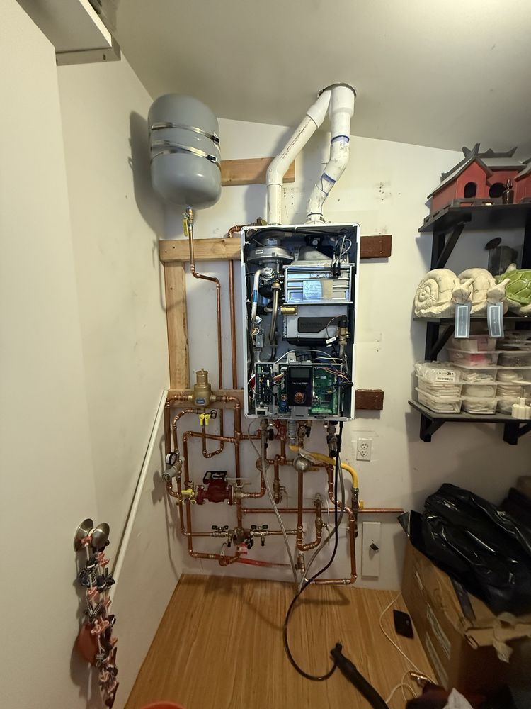 Fully installed tankless water heater with copper piping and expansion tank